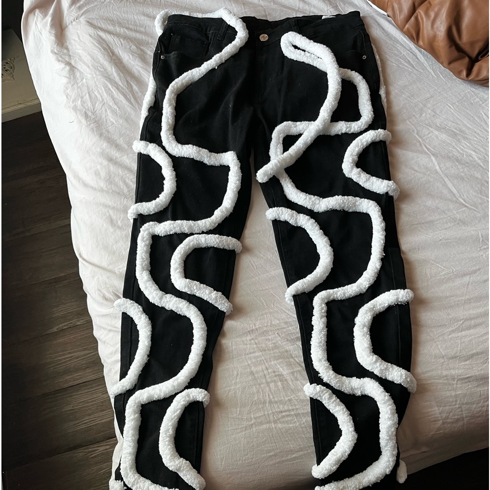 Black cords stacked denim jeans